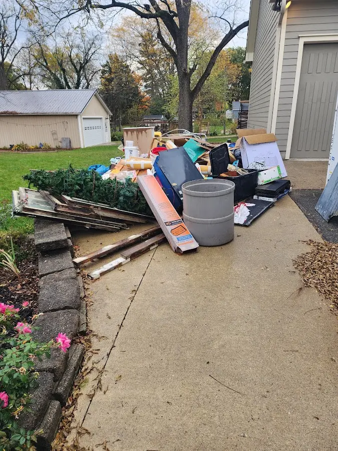 Dumpster being loaded with debris for Roofing Dumpster Rental in Fernley